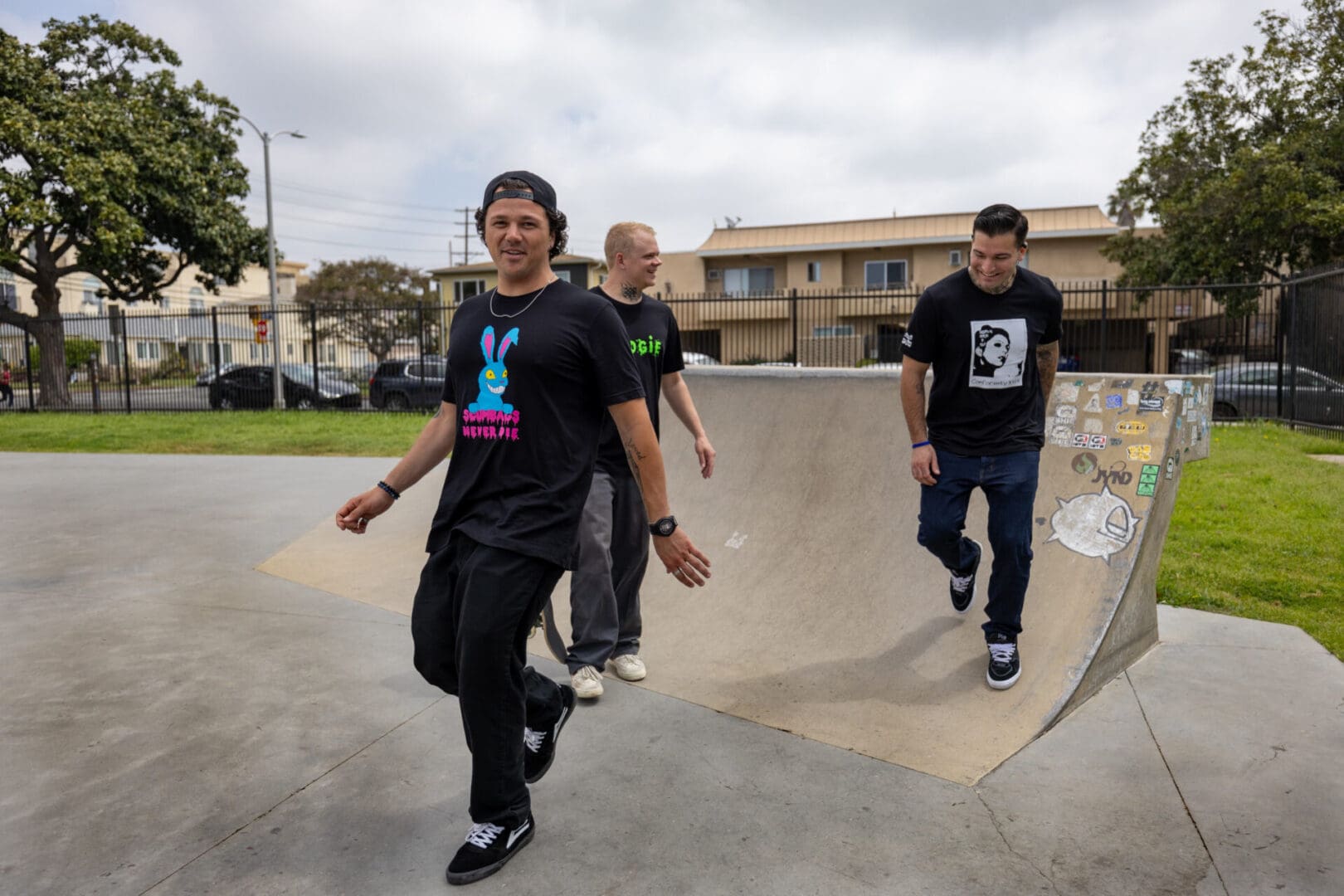 A group of young men riding skateboards on top of ramps.